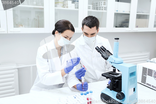 Image of young scientists making test or research in lab