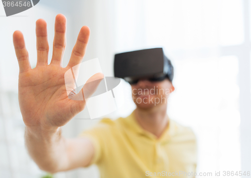 Image of young man in virtual reality headset or 3d glasses