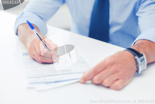 Image of man signing a contract