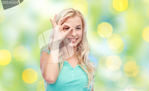 Image of young woman making ok hand gesture