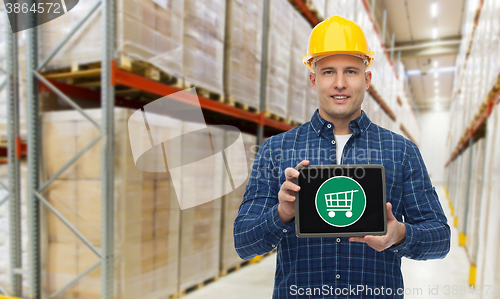 Image of happy businessman with tablet pc at warehouse
