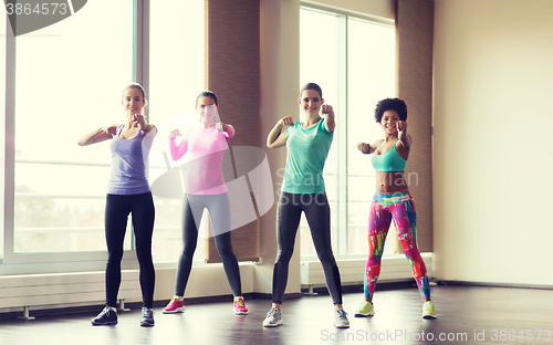 Image of group of happy women working out in gym