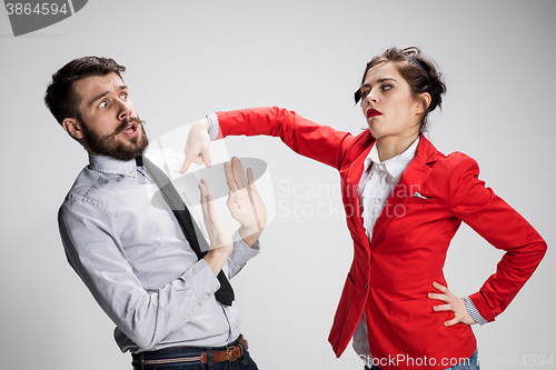 Image of The sad business man and woman conflicting on a gray background