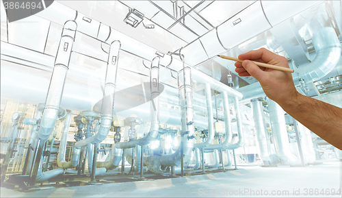 Image of man\'s hand draws a design of factory combined with photo of mode