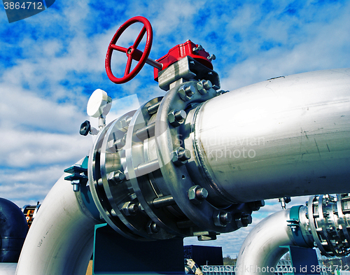 Image of Industrial zone, Steel pipelines and valves against blue sky