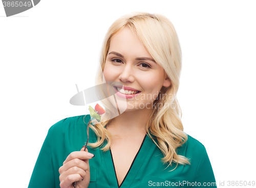 Image of smiling young woman eating vegetable salad