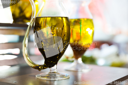 Image of close up of glass jug with extra vergin olive oil