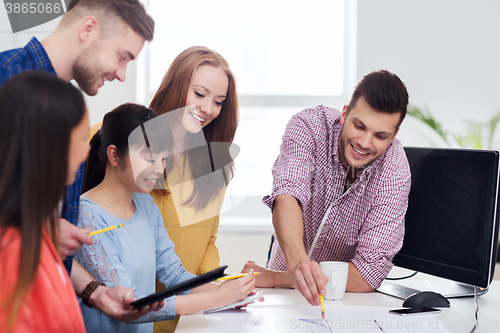 Image of happy creative team or students working at office