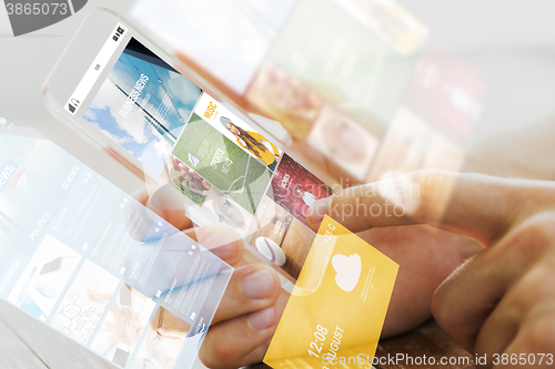 Image of close up of male hand with news on smartphone