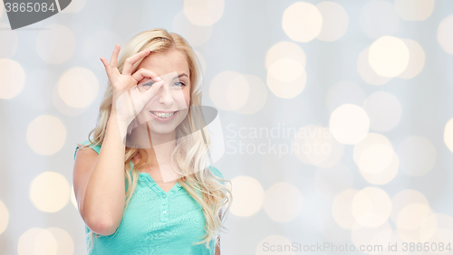 Image of young woman making ok hand gesture