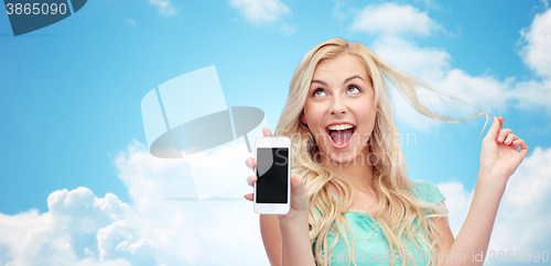 Image of happy young woman or teenage girl with smartphone