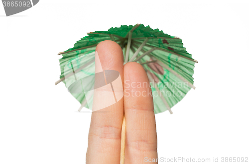 Image of close up of two fingers with cocktail umbrella