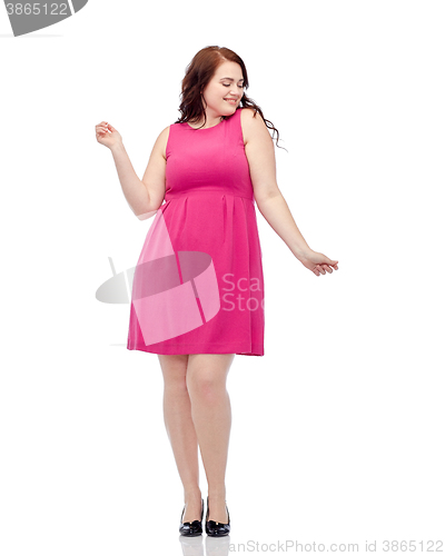 Image of happy young plus size woman dancing in pink dress