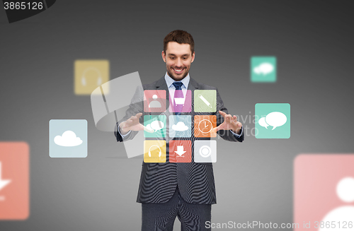 Image of businessman working with menu icons projection