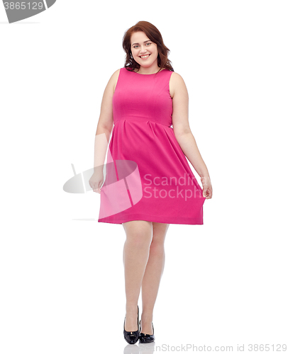 Image of happy young plus size woman posing in pink dress