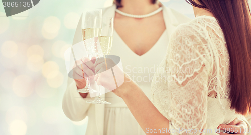 Image of close up of lesbian couple with champagne glasses