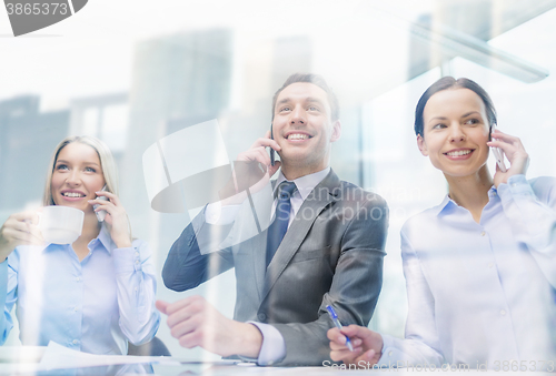 Image of business team with smartphones having conversation