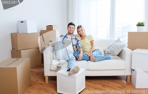 Image of happy couple with big cardboard boxes at new home