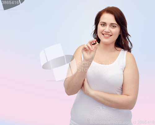 Image of happy plus size woman in underwear with pill