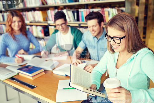 Image of students reading and drinking coffee in library