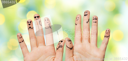 Image of close up of hands and fingers with smiley faces