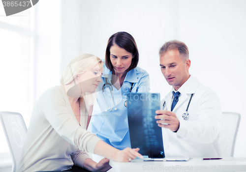 Image of doctors with patient looking at x-ray