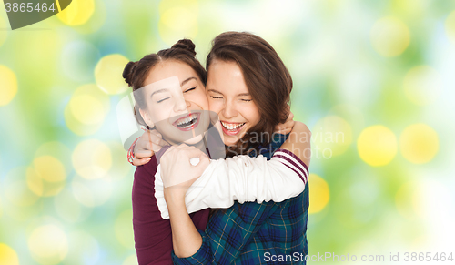 Image of happy smiling pretty teenage girls hugging