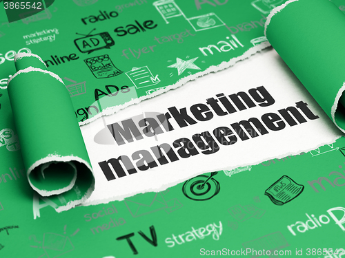 Image of Marketing concept: black text Marketing Management under the piece of  torn paper