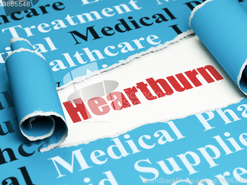 Image of Healthcare concept: red text Heartburn under the piece of  torn paper
