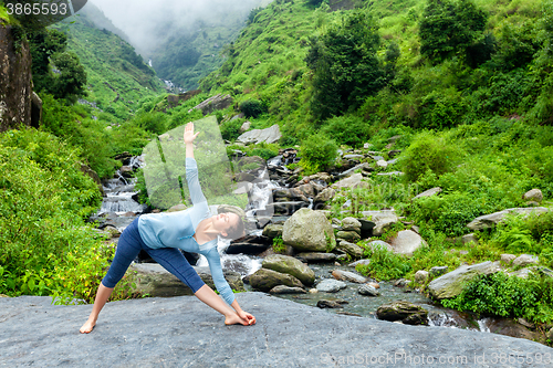 Image of Woman doing Ashtanga Vinyasa yoga asana Utthita trikonasana