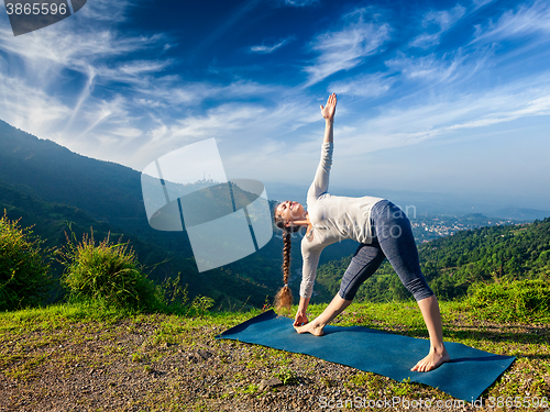 Image of Woman doing Ashtanga Vinyasa yoga asana Utthita trikonasana