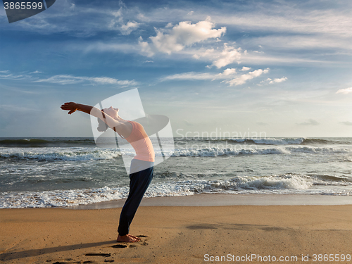 Image of Woman doing yoga Sun salutation Surya Namaskar 