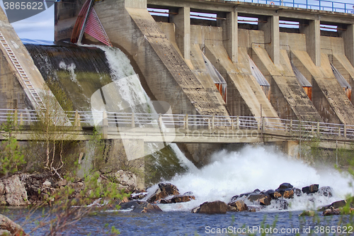 Image of Powerful water discharge through gate of power plant