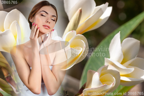 Image of Beautiful girl with white frangipani flowers 