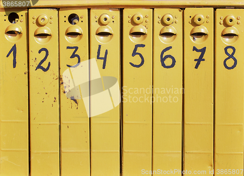 Image of eight old mail boxes