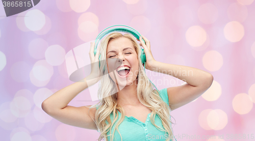 Image of happy young woman or teenage girl with headphones