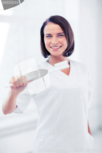 Image of dentist with toothbrush in hospital