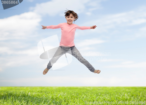 Image of happy little girl jumping in air