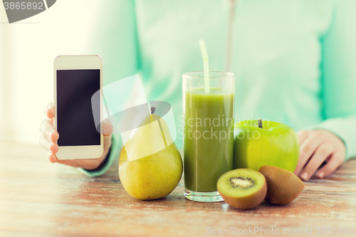 Image of close up of woman hands smartphone and fruit juice
