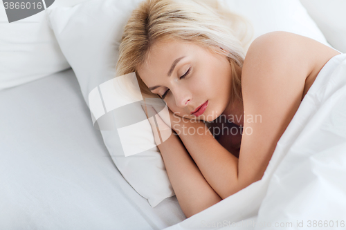 Image of young woman sleeping in bed at home bedroom