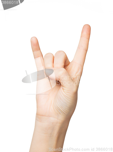 Image of close up of woman hand showing rock sign