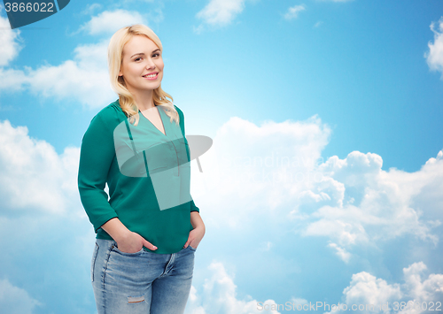 Image of smiling young woman in shirt and jeans