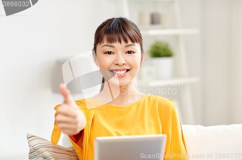 Image of happy asian woman with tablet pc and thumbs up