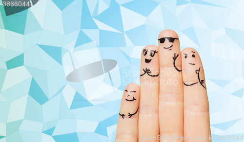 Image of close up of four fingers family with smiley faces