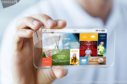 Image of close up of male hand with news on smartphone