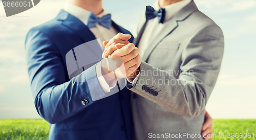 Image of close up of happy male gay couple dancing
