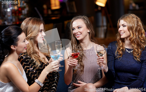 Image of happy women with drinks at night club