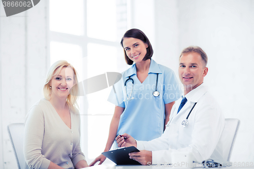 Image of doctor and nurse with patient in hospital