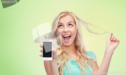 Image of happy young woman or teenage girl with smartphone