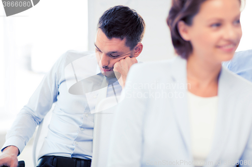 Image of tired businessmen sleeping on conference